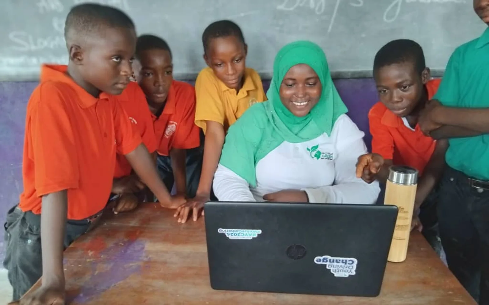 Students learning with a Globally Green facilitator in their classroom