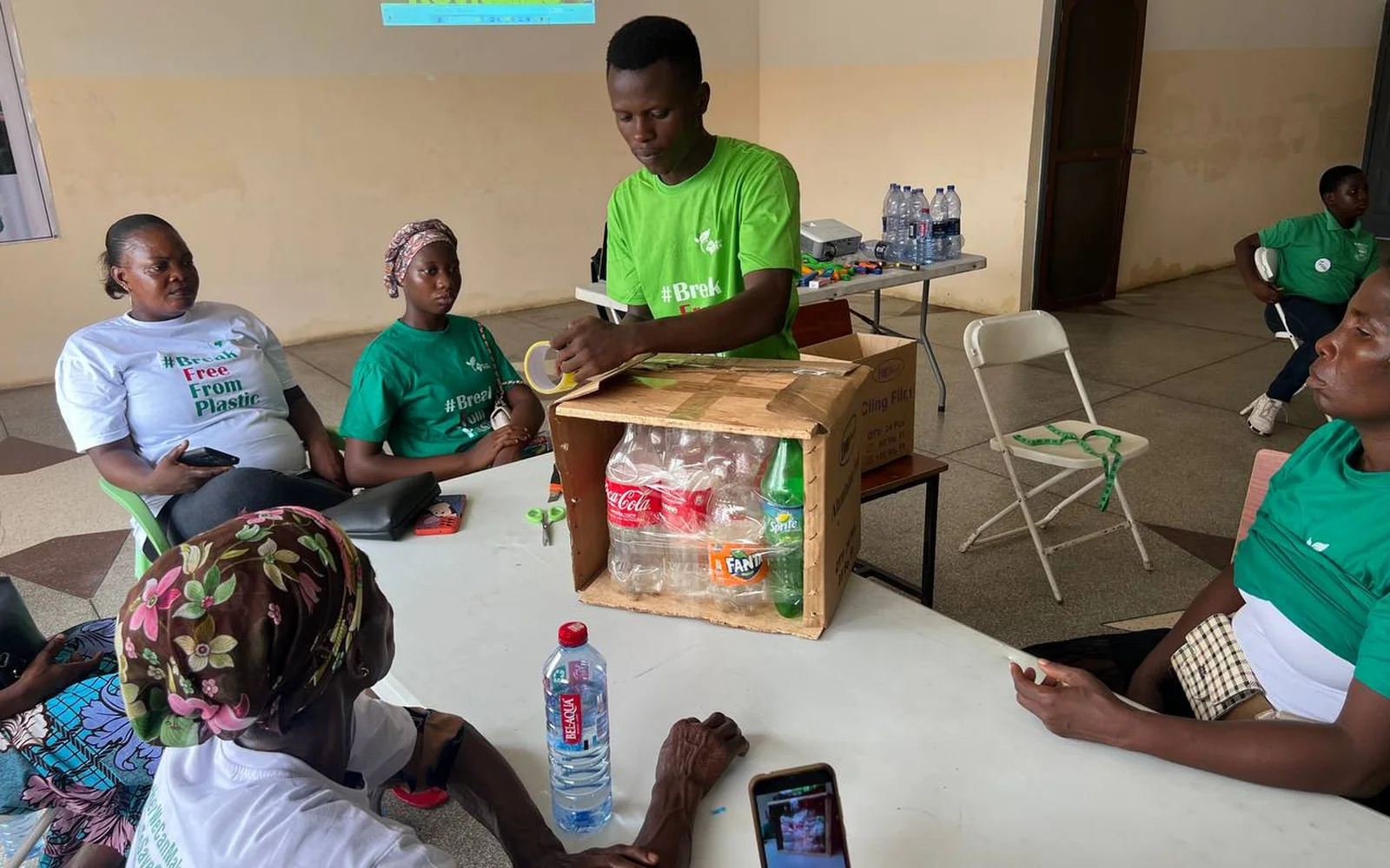 A Recycle Arts facilitator demonstrating how plastic bottles can be reused